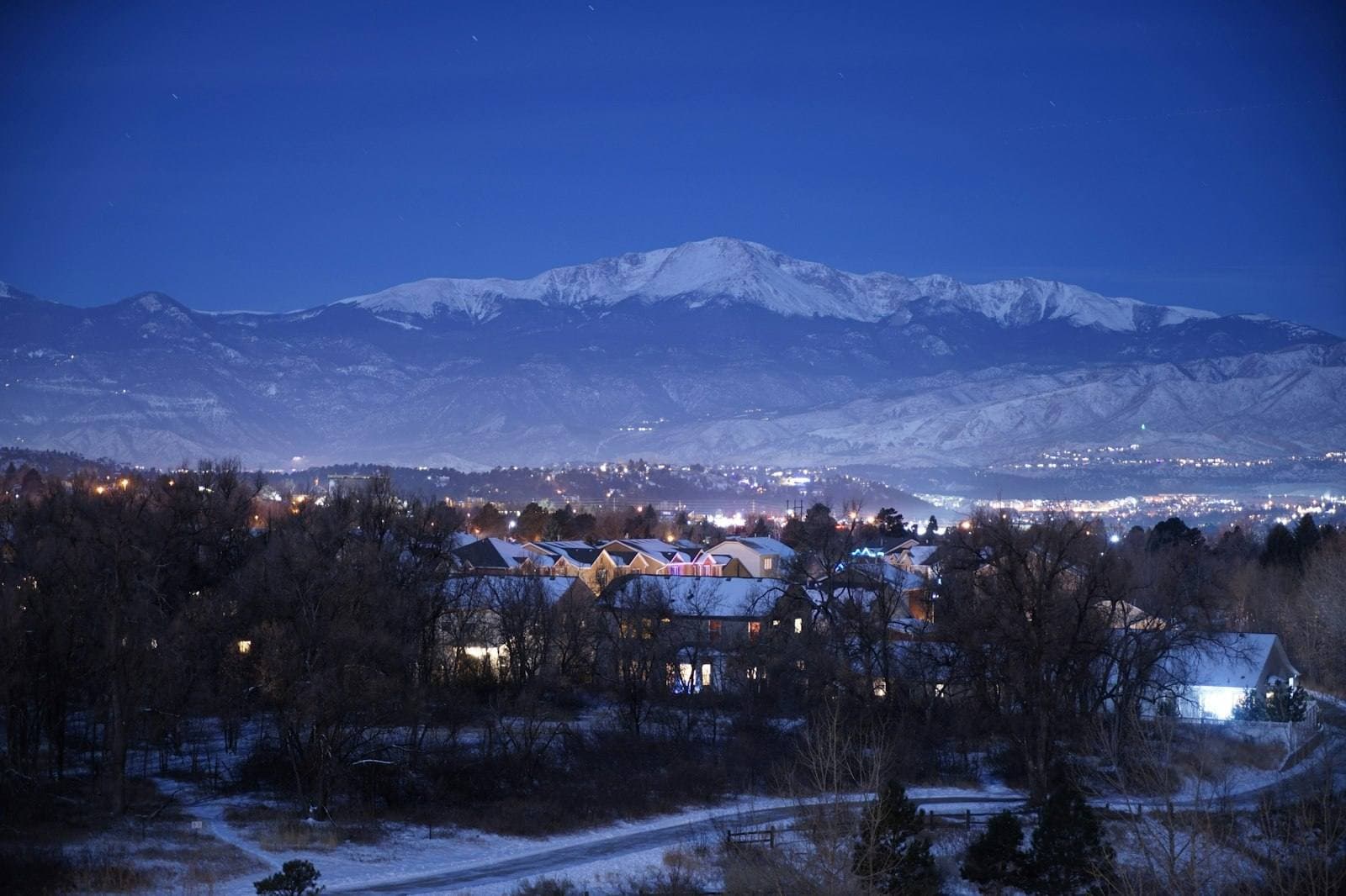 Colorado homes beneath snow-covered mountains. Boulder County appeal guide.