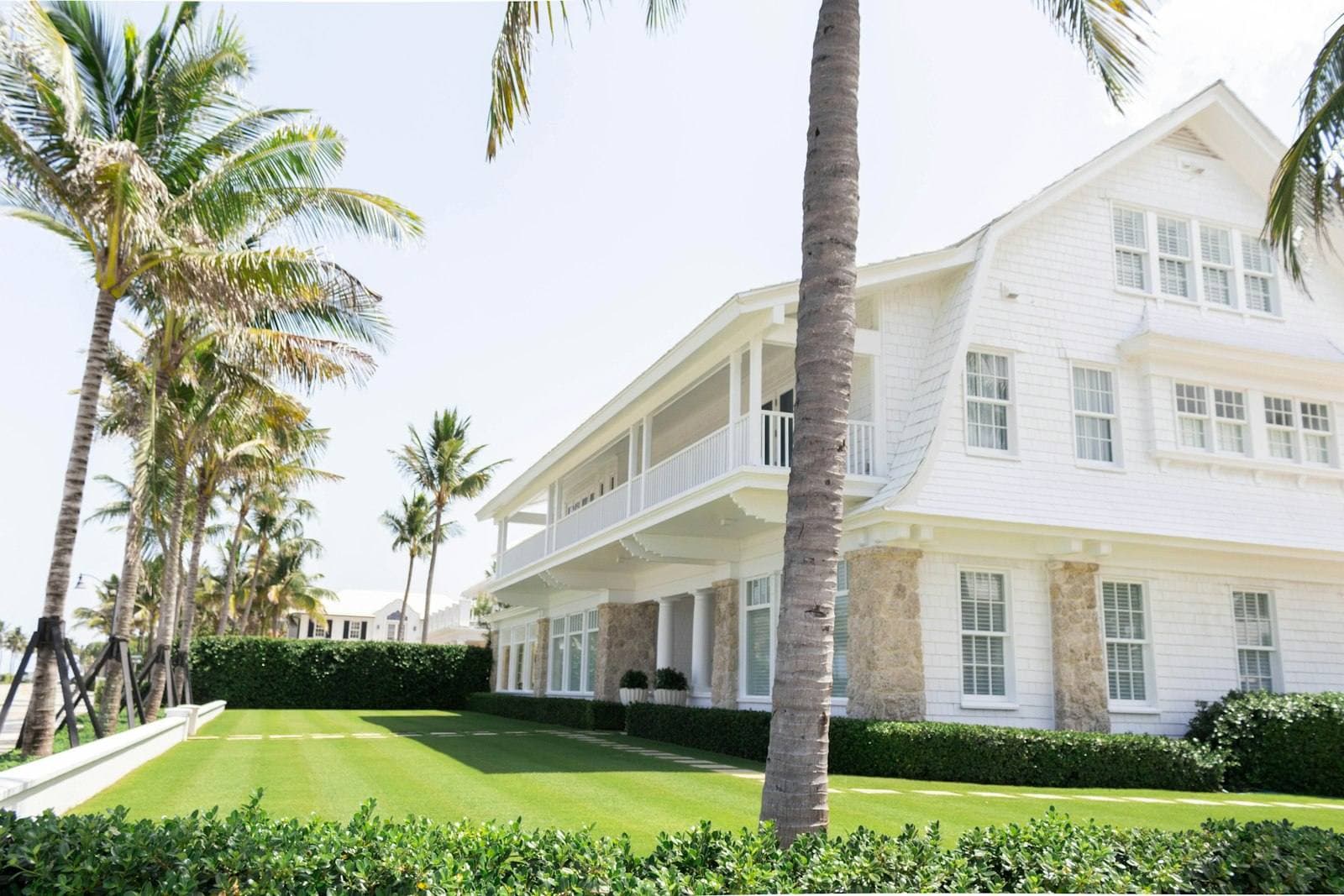 White Florida house framed by palm trees. Collier County appeal guide.
