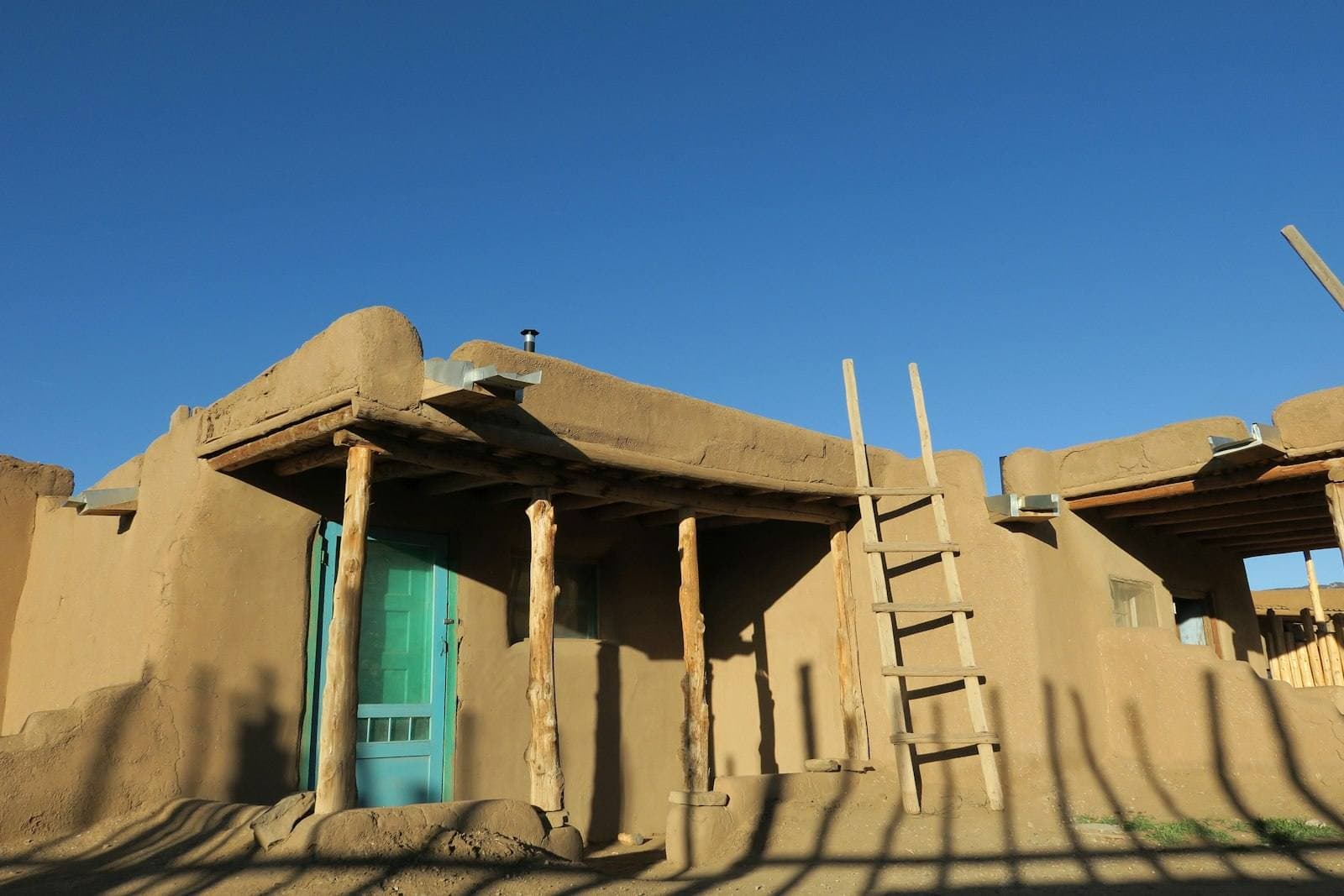 Adobe New Mexico home under blue sky