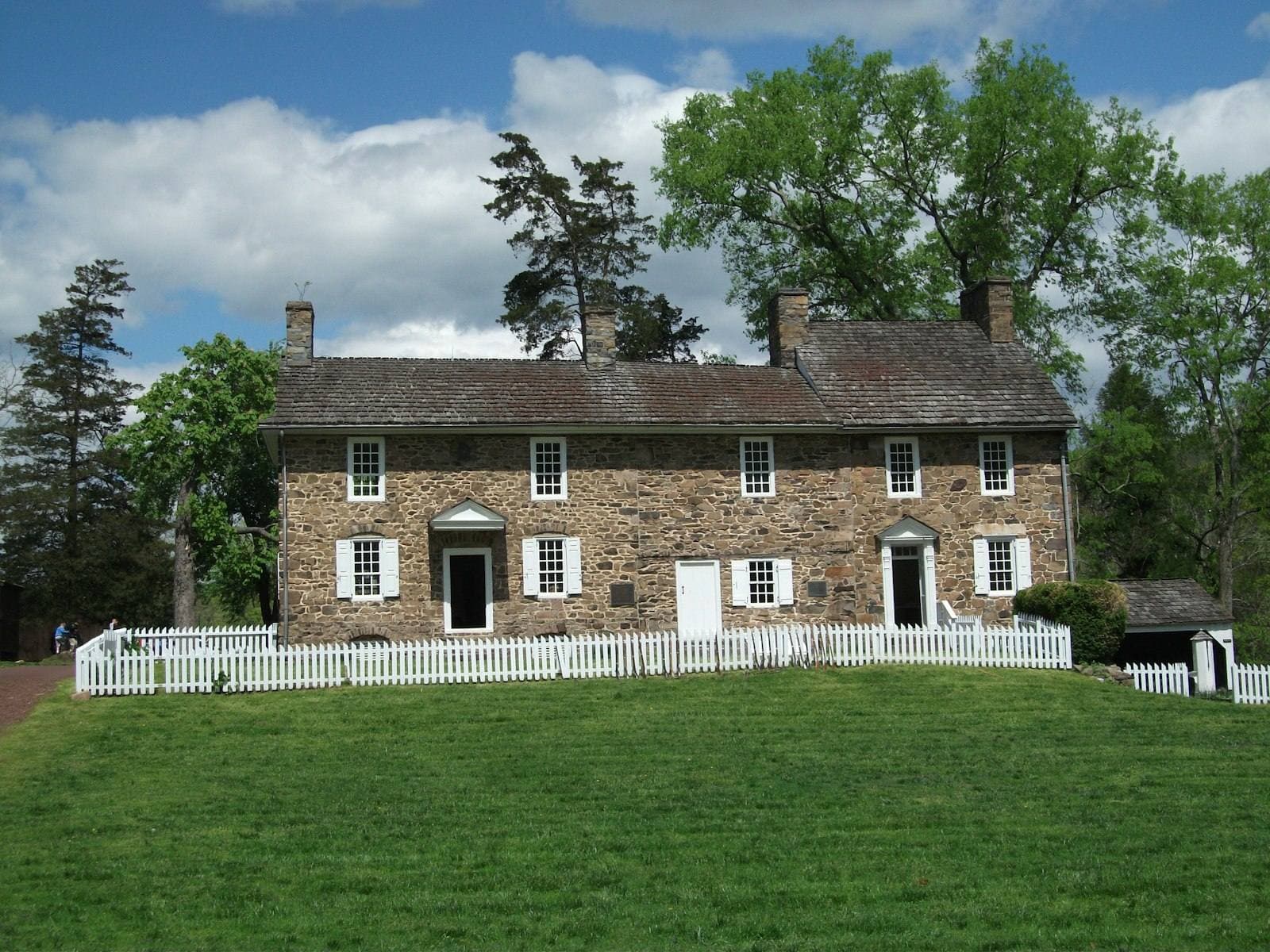 Pennsylvania stone house with picket fence. Juniata County appeal guide.