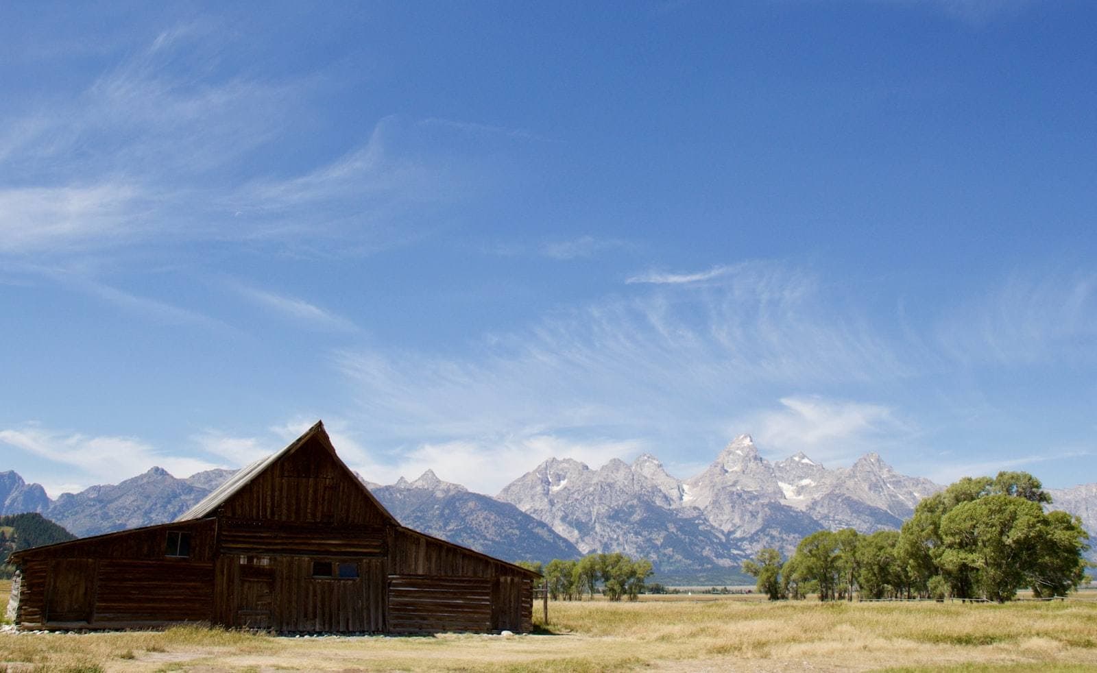 Wyoming ranch house beneath snow-capped peaks. Laramie County appeal guide.